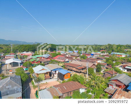 Aerial view of local residential neighborhood roofs. Urban housing development from above. Top view. Real estate in Sukhothai urban city town, Thailand. Property real estate. 109295972