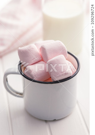 Sweet marshmallows candy in cup on kitchen table. Sweet marshmallows candy in cup on kitchen table. 109296724