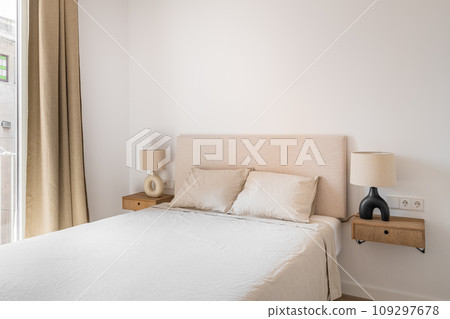 Double bed with pillows and blanket in minimalist bedroom 109297678