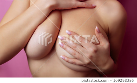 Big Breasts of a sexy woman, close up. Plastic correction and surgery concept. Big Breasts of a sexy woman, close up. Plastic correction and surgery concept. 109298386