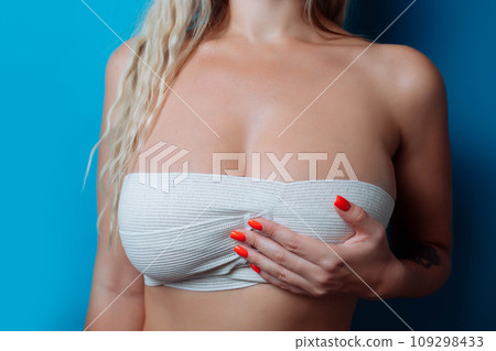close up picture of big boobs in bandage after surgery, sexual sizebandage breast enlargement. 109298433