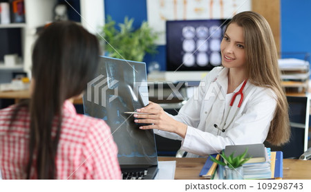 Female patient and doctor with spine x-ray scan meet in hospital 109298743