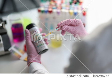 Chemist scientist holding ph test in hands closeup 109298756