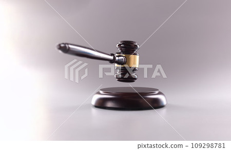 Wooden judge gavel in air on gray background Wooden judge gavel in air on gray background 109298781