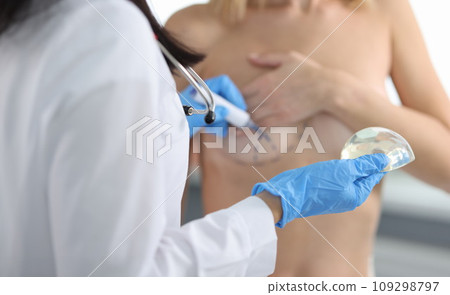 Doctor draws marks on female breast cosmetic surgery operation Doctor draws marks on female breast cosmetic surgery operation 109298797