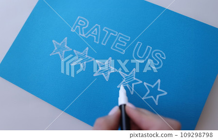 Handwritten review rate us and star rating on blue background Handwritten review rate us and star rating on blue background 109298798