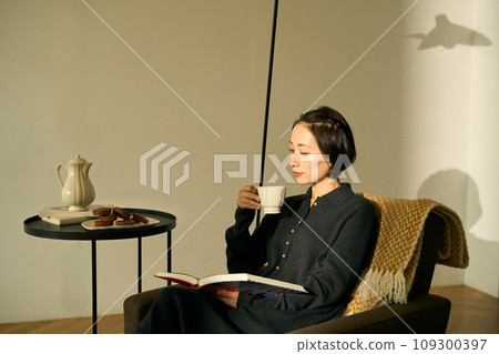 Woman relaxing on the sofa at sunset Woman relaxing on the sofa at sunset 109300397