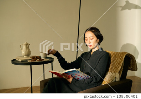 Woman relaxing on the sofa at sunset Woman relaxing on the sofa at sunset 109300401
