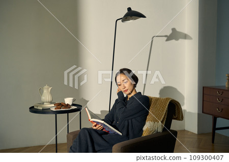 Woman relaxing on the sofa at sunset Woman relaxing on the sofa at sunset 109300407