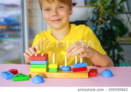 eco wooden toys. The child collects a sorter. Educational logic toys for kids. Games for Child Development eco wooden toys. The child collects a sorter. Educational logic toys for kids. Games for Child Development 109300662