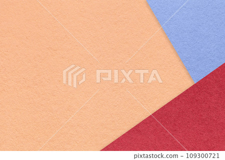 Texture of craft coral color paper background with blue and red border. Vintage abstract peach cardboard. Texture of craft coral color paper background with blue and red border. Vintage abstract peach cardboard. 109300721