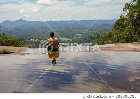 boy looks the view at waterfall in Domingos Martins, Espirito Santo state, Brazil 109300793
