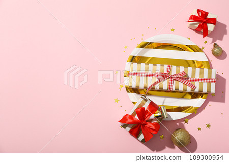 Gift boxes and plate on pink background, space for text Gift boxes and plate on pink background, space for text 109300954