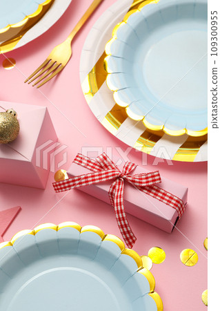 Gift boxes, plates and cutlery on pink background, close up 109300955