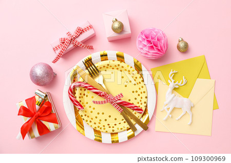 Plates, cutlery, gift boxes and envelopes on pink background, top view 109300969
