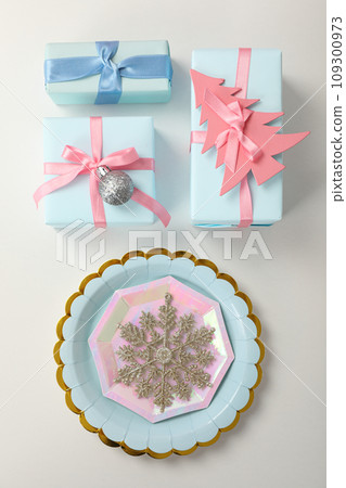Gift boxes and plates on light background, top view Gift boxes and plates on light background, top view 109300973