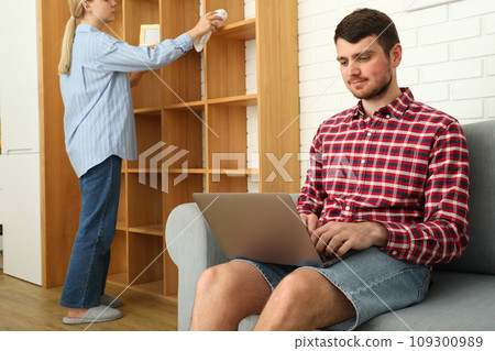 A man works on a laptop on a sofa 109300989
