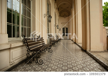 A beautiful bench near the wall of the house A beautiful bench near the wall of the house 109301379