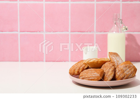 Madeleine cakes and milk bottle on pink background, space for text Madeleine cakes and milk bottle on pink background, space for text 109302233