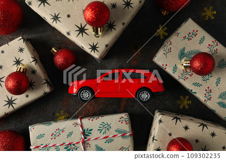 Christmas gifts with a car, top view. Christmas gifts with a car, top view. 109302235