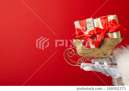 New Year's sleigh with gifts in Santa's hands. 109302271