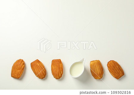 Madeleine cakes and cream on white background, space for text 109302816