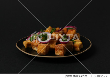 Fried tofu in a bowl on a dark background 109303527