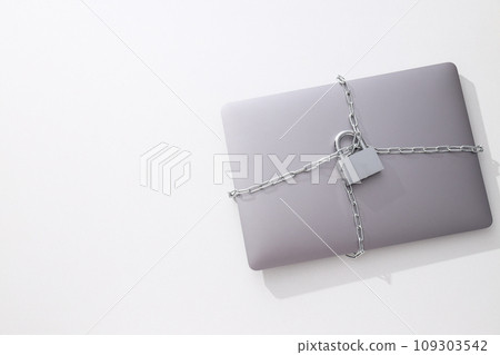 The laptop is wrapped in a chain with a lock 109303542