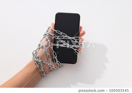 The smartphone is encased in a chain with a lock The smartphone is encased in a chain with a lock 109303545