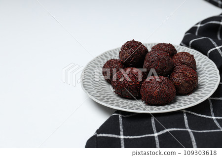 Brigadeiro in plate and towel on white background, space for text 109303618