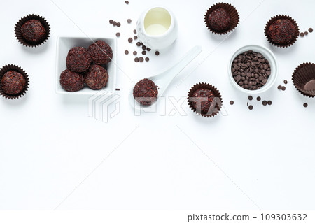 Brigadeiro and chocolate chips in bowls on white background, space for text Brigadeiro and chocolate chips in bowls on white background, space for text 109303632