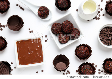 Brigadeiro and chocolate in bowls on white background, top view 109303633