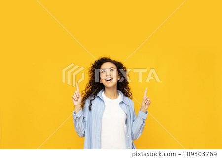 Young attractive girl on a yellow background Young attractive girl on a yellow background 109303769