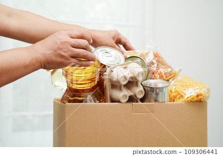 Foodstuffs in donation box for volunteer to help people. Foodstuffs in donation box for volunteer to help people. 109306441