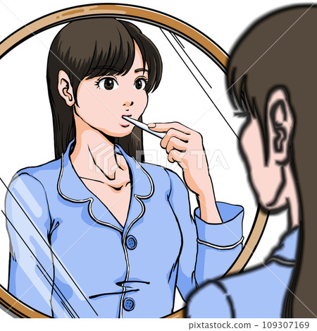 A young woman in pajamas stands in front of the sink and brushes her teeth 109307169