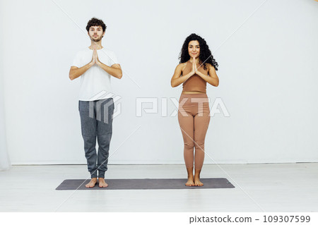 Man And Woman Doing Couple Yoga Fitness Gymnastics Asana Man And Woman Doing Couple Yoga Fitness Gymnastics Asana 109307599