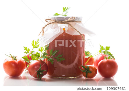 Cooked homemade tomato juice canned in a jar of natural tomatoes. 109307681