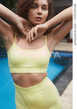 beautiful girl in yellow.young brunette woman near swimming pool beautiful girl in yellow.young brunette woman near swimming pool 109308186