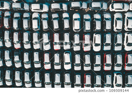 Aerial top down view of new cars parked in car parking lot. Car dealer parking lot full of new automobiles. New cars lined up for import and export business. Aerial top down view of new cars parked in car parking lot. Car dealer parking lot full of new automobiles. New cars lined up for import and export business. 109309144