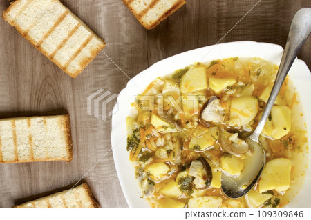Mushroom soup in a white bowl on a beige background 109309846