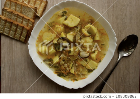 Mushroom soup in a white bowl on a beige background 109309862