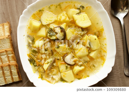 Mushroom soup in a white bowl on a beige background 109309880