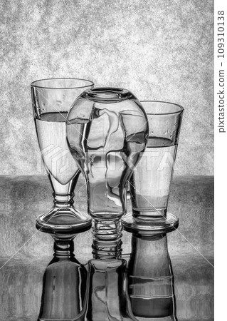 Still life with glass objects on a gray background 109310138