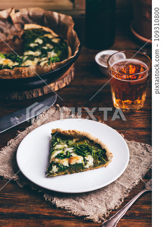 Slice of Spinach Galette with Parmesan on White Plate Slice of Spinach Galette with Parmesan on White Plate 109310800