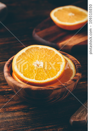 Sliced orange in a wooden bowl Sliced orange in a wooden bowl 109310850