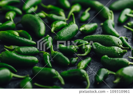 Green Jalapeno Peppers on Concrete Background Green Jalapeno Peppers on Concrete Background 109310961