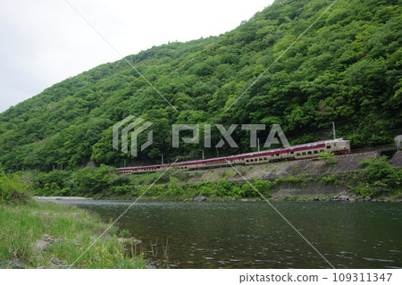 Limited Express Sunrise Izumo Hakubi Line runs along the river near Hoya 109311347