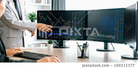 Stock broker present interested stock to skilled businesswoman. Burgeoning.. Stock broker present interested stock to skilled businesswoman. Burgeoning.. 109315377