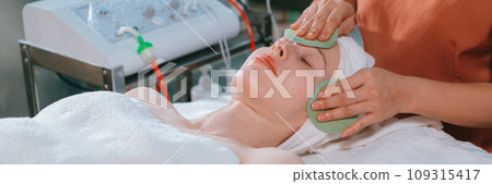 Attractive caucasian woman receive electrical facial treatment. Tranquility. Attractive caucasian woman receive electrical facial treatment. Tranquility. 109315417