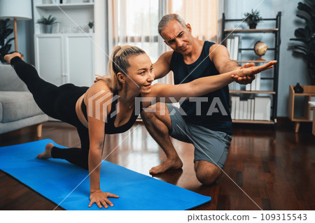 Happy active senior couple in sportswear doing yoga. Clout 109315543